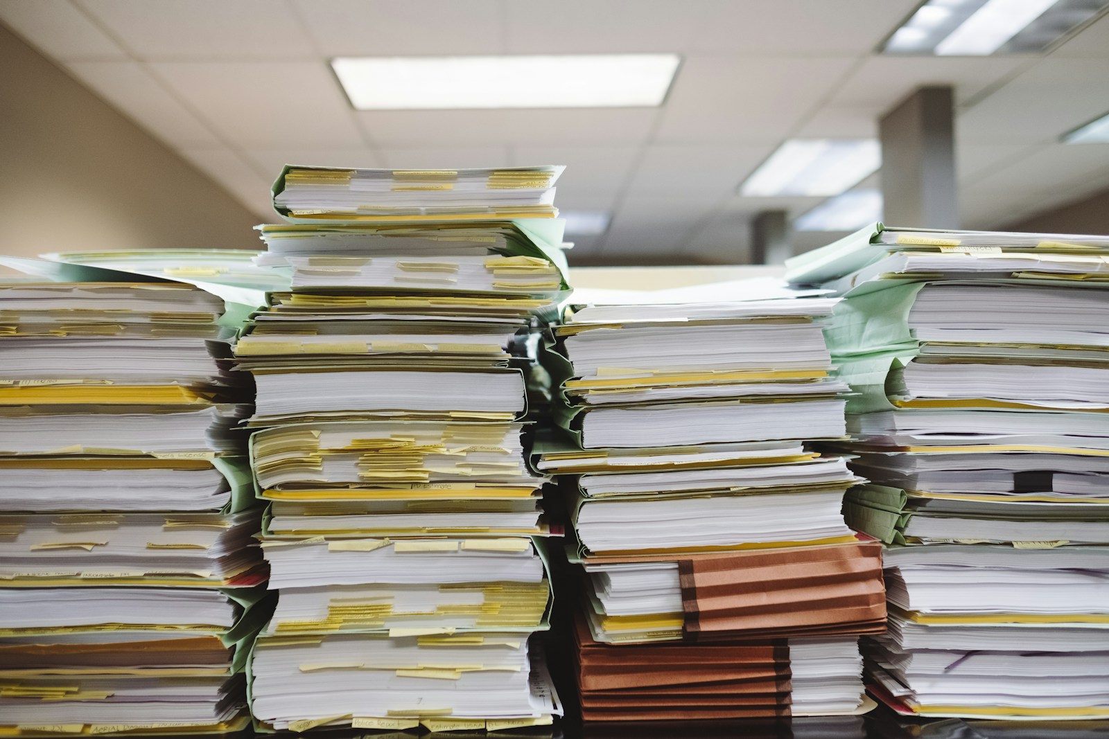 Stacks of paper tax files piled up in an office