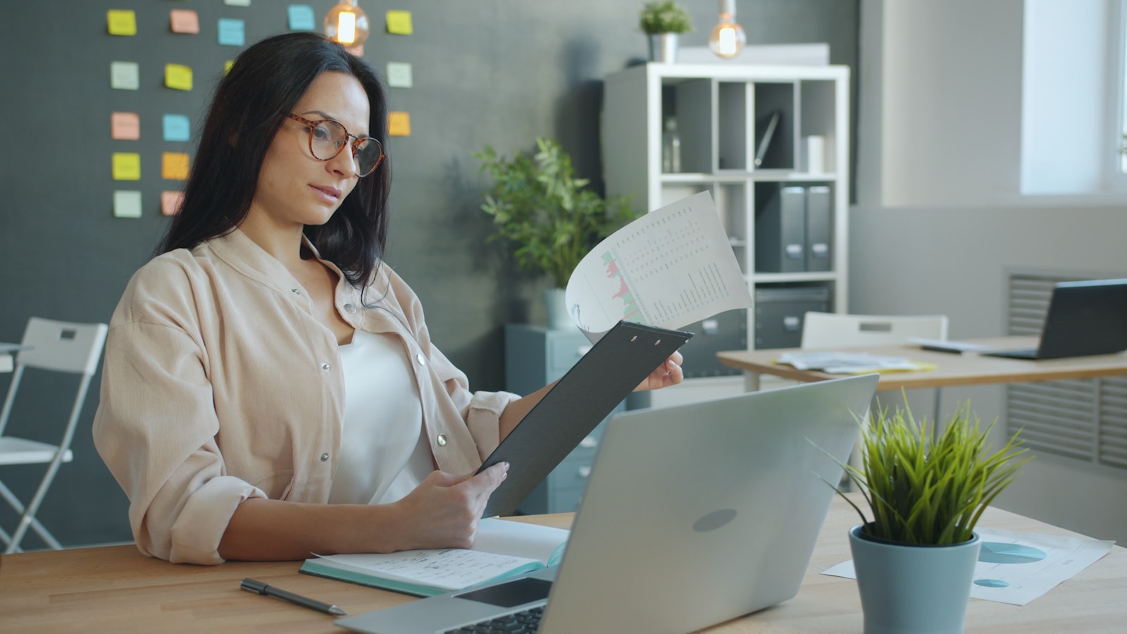 Business owner reviewing a financial report at her desk