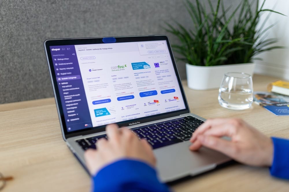 Accountant reviewing Shopify store financials with calculator and reports